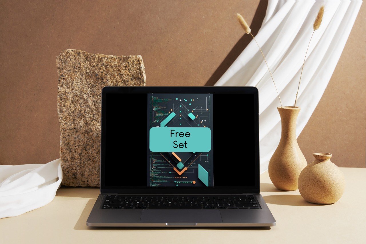 A dark gray laptop sits open on a beige tabletop, displaying a digital cover with the words 'Free Set.' The scene is styled with a textured stone block, white draped fabric, and two beige ceramic vases in the background.