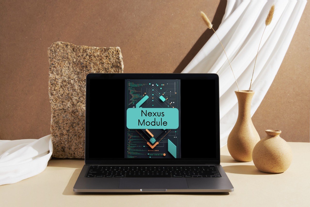 A laptop sits on a tabletop in a styled interior scene, displaying a digital cover titled 'Nexus Module.' The setting includes a tan wall, draped white fabric, a stone block, and two beige vases with dried stems.